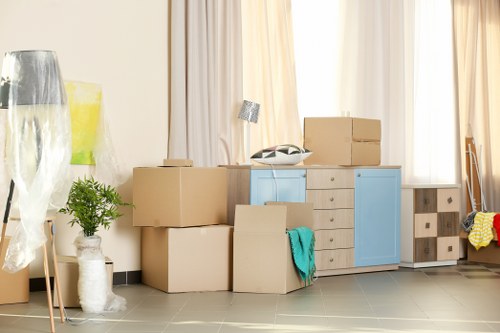 Removal team handling a flat move in Wandsworth with boxes and furniture