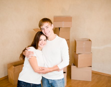 Professional movers using proper lifting technique with furniture