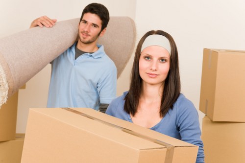 Professional piano movers protecting floors and doorways inside a Wandsworth property
